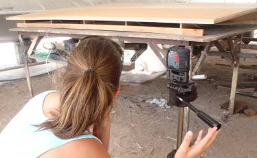 Amanda using her trusty laser to level up our frame/mold