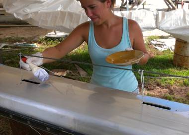 Amanda applying Nyalic to the mast with her make-shift brush