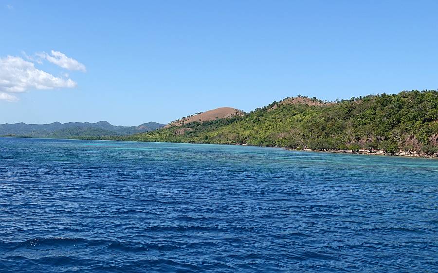 Our Apo Is anchorage, looking north. Note the extensive reef on the right.