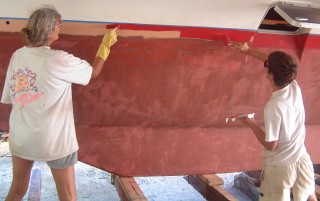 Sue and Chris paint the starboard hull