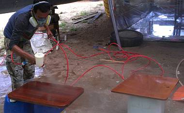 Spraying Awl Brite on some of the salon table pieces