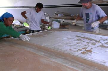 Houa, Baw, & Jon laying a single sheet on the bimini stbd side