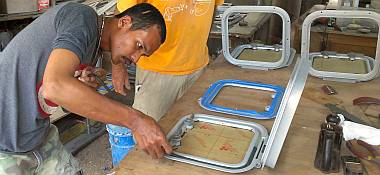 Baw installing a gasket into the channel of a deck hatch