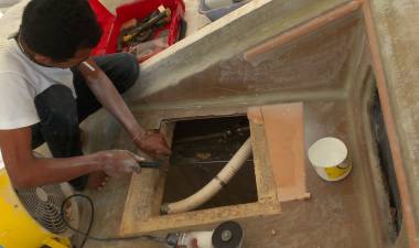 Baw cutting away foam & glass to put down his new hatch-frame