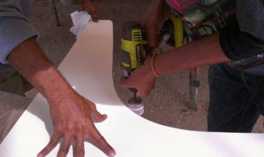 Baw using a rotary sander to smooth out a big curved nonskid