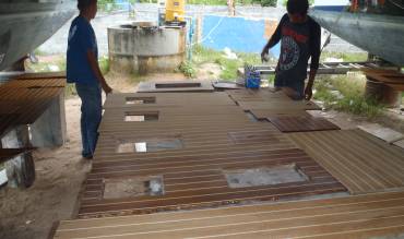 Our varnish (& wood) shop under a neighboring catamaran