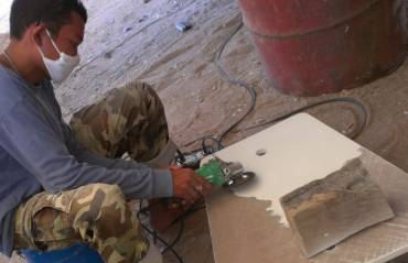 Ben removing bad Nippon epoxy paint from a hatch