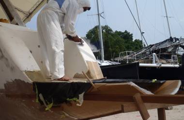 Boy grinding the gelcoat off stbd transom, above extension