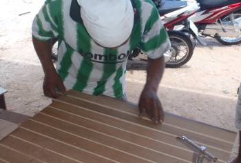 Houa fitting a new ash strip to a teak & holly floorboard