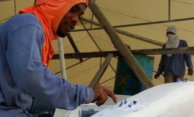 Chai putting filler on top of the reinforced patches, with the bolts