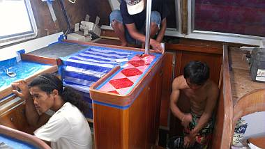 Chambron, Heru, & Yando sanding the high-wear trim in the salon