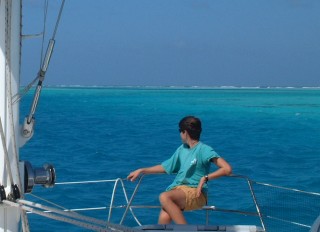 Chris riding the bow as we dodge reefs in Los Roques