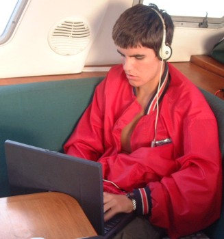 Chris typing an email as we sail