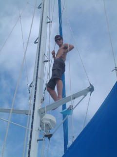 Chris climbs the mast steps to the spreaders to watch for reefs.