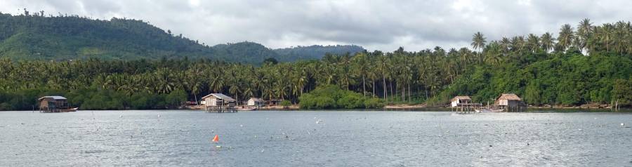 The floats are seaweed farms. We anchored off the middle house.