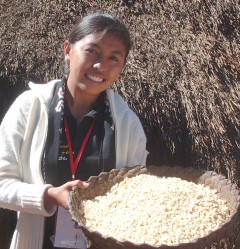 Nita holds up drying corn at her family home