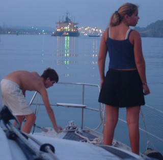 Chris prepares lines on the bow for our first lock, 5 AM