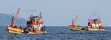 Fishing boats cross our path as we head for Langkawi