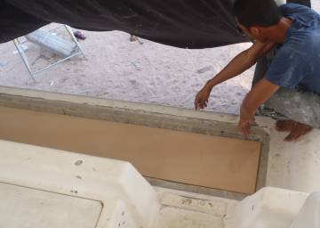 Max checks the fit of the last bit of foam on our aft-deck