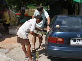 Gasoline from whiskey bottles. Not a cheap option. Phuket, Thailand.