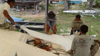 Jon pitching in to lay the 2nd layer of glass on port side-deck