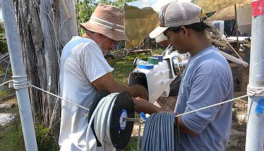 Jon and Heru prepare to pull some wires up the mast