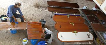 Heru and Yando sanding doors under Ocelot's stern