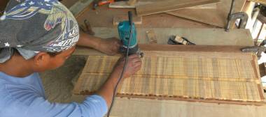 Houa cutting slots in the teak strips for the lattice with his router