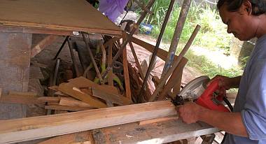 Houa cutting up a big piece of teak, salvaged from a friend's boat