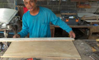 Houa building galley panels in his workshop in front of Ocelot