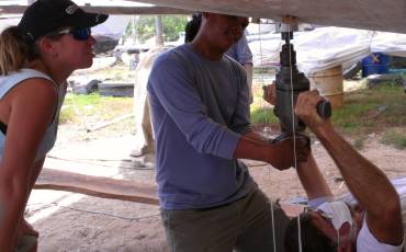 Lining up the drill with strings to remove the lower rudder bearing