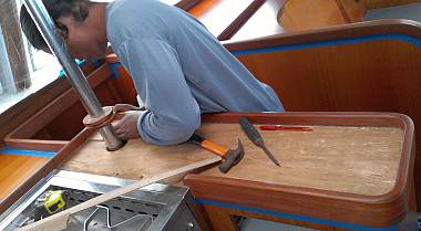 Houa making a template for the formica to the right of the stove