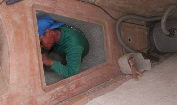 Houa putting epoxy mud on the underside of the fo'c's'l shelf