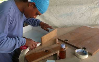 Our carpenter Houa having fun playing with wood