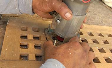 Houa beveling the edge of each tiny square of our teak grate