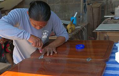 Houa worked all day installing hinges in our beautiful tables