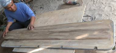 Houa fitting the center teak section into 1 side of the cockpit table