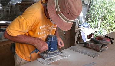 Jon's hat sanding the supports for the shower drain systems