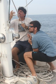 Jon & Chris raise the mainsail as we make our way north to Thailand