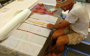 Jon cutting 200g fiberglass for the tops of the rudders