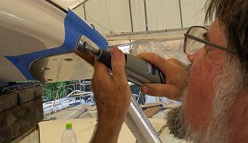 "Massaging" a bimini leg mounting hole with the Dremel