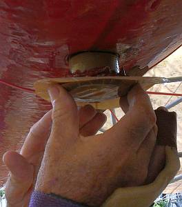 Push the phenolic epoxy against the hull