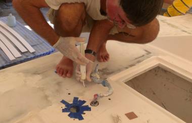 Injecting epoxy into anchor winch holes above a chain locker