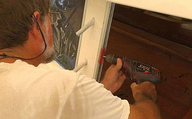 Using a fiber wheel to dig silicone out of the window frame