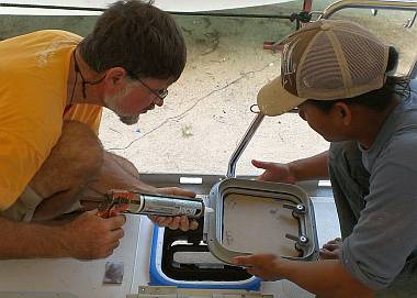 Jon and Heru installing the starboard aft small deck hatch