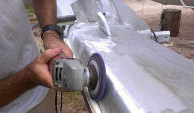 Jon ridding the mast of grinder marks & black corrosion pits