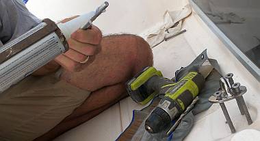 Gooping up the long pad-eye bolts by the mast