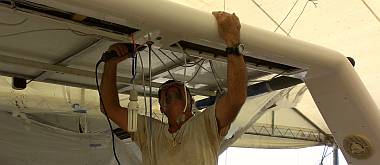 Jon drilling & bolting the solar panels to the back of the targa-bar