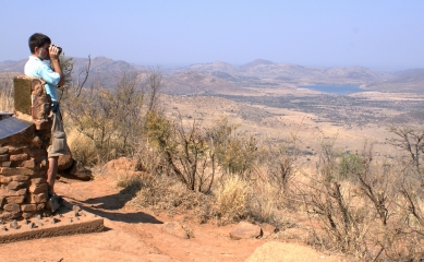 Jon with binocs at Pilanesberg National Park, South Africa