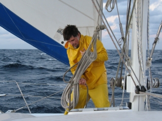 Jon reefs the mainsail, mid-Channel